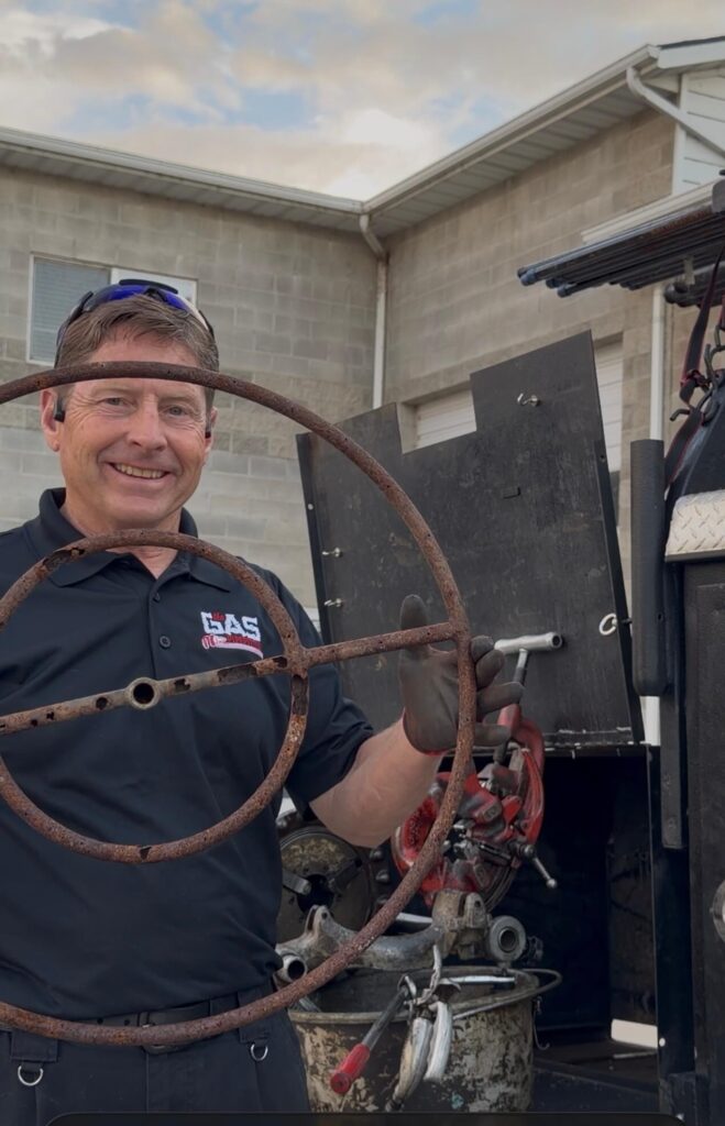 Gas line installation specialist setting up residential gas supply